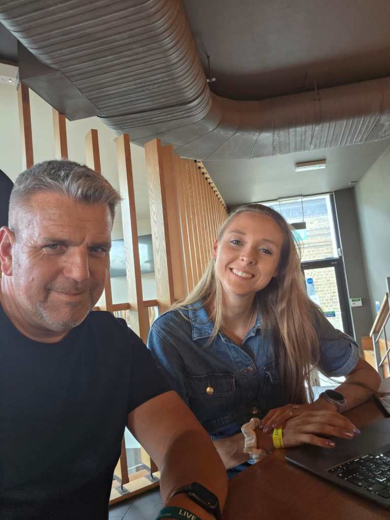 Jon and Sam sat down, chatting and smiling at the camera.